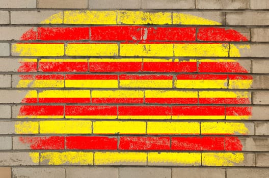 Chalky and grunge catalonia flag painted with color chalk on brick wall