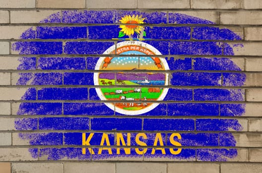 Chalky and grunge american state of kansas flag painted with color chalk on brick wall