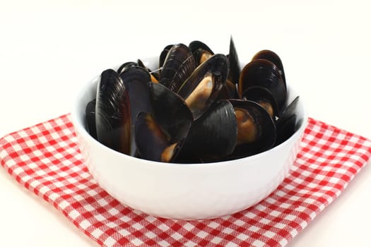 fresh cooked mussels in a white bowl