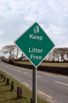 keep litter free road sign on a quiet road entering a town in ireland