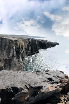 view from the cliffs edge on a rocky landscape of the burren in county clare ireland