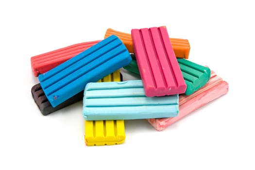 Colorful children&#039 s plasticine bricks on a white background