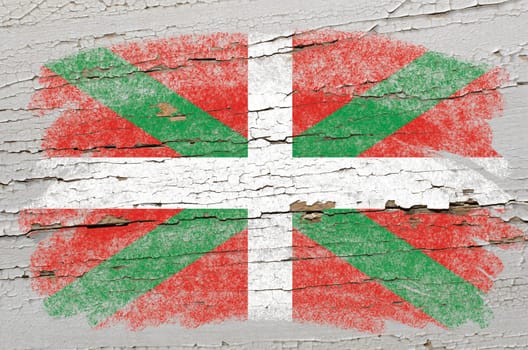 Chalky basque flag precisely painted with color chalk on grunge wooden texture