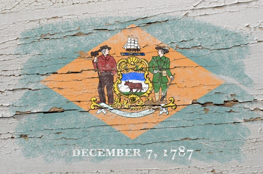 Chalky american state of delaware flag precisely painted with color chalk on grunge wooden texture