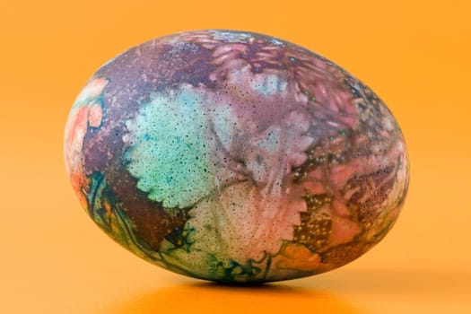 colorful ornate easter egg, isolated on orange background