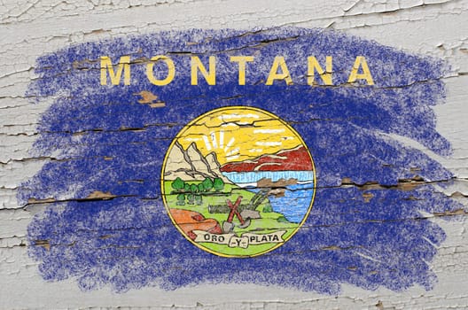 Chalky american state of montana flag precisely painted with color chalk on grunge wooden texture