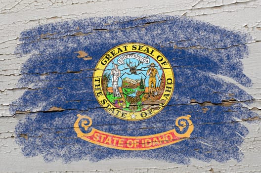Chalky american state of idaho flag precisely painted with color chalk on grunge wooden texture