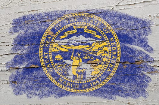 Chalky american state of nebraska flag precisely painted with color chalk on grunge wooden texture