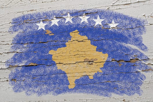 Chalky kosovo flag precisely painted with color chalk on grunge wooden texture
