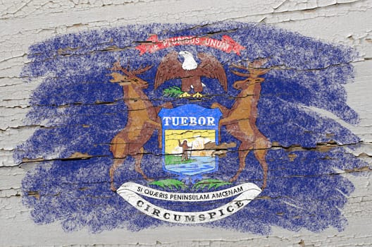 Chalky american state of michigan flag precisely painted with color chalk on grunge wooden texture