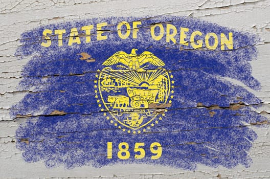 Chalky american state of oregon flag precisely painted with color chalk on grunge wooden texture