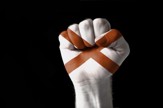 Low key picture of a fist painted in colors of american state flag of alabama