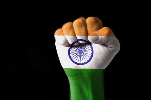 Low key picture of a fist painted in colors of india flag