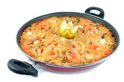 seafood rice with shrimp and lemon shrimp clams squid in paellera on white background