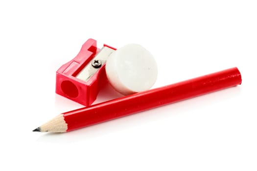 red plastic sharpener white rubber eraser and pencil on white background