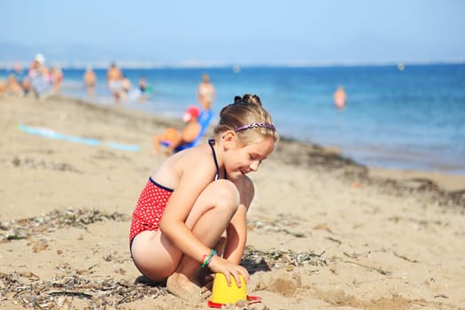 Kids playing with plastic toys on the beach