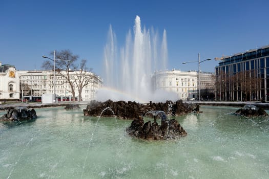 Hochstrahlbrunnen Schwarzenbergplatz,Vienna,in the center of the city with rainbow
