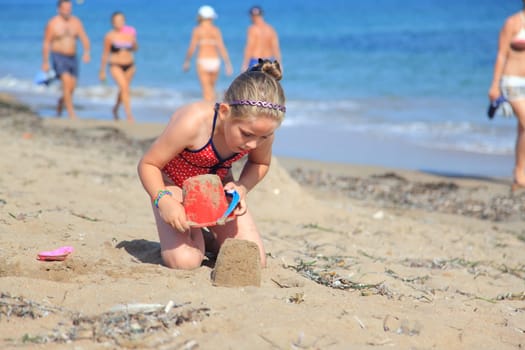 Kids playing with plastic toys on the beach
