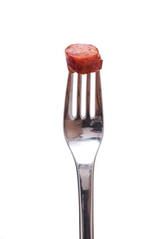 Sausage pepper biter and a fork against white background