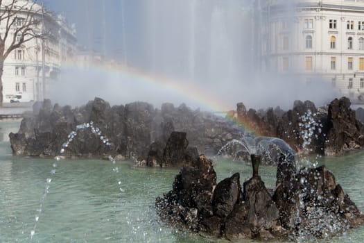 Hochstrahlbrunnen Schwarzenbergplatz,Vienna,in the center of the city with rainbow