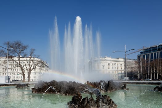 Hochstrahlbrunnen Schwarzenbergplatz,Vienna,in the center of the city with rainbow