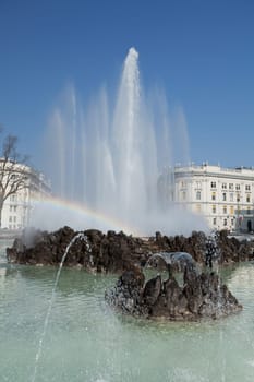 Hochstrahlbrunnen Schwarzenbergplatz,Vienna,in the center of the city with rainbow