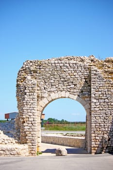 Ancient door in a stone wall, entrance to the city
