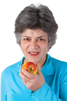 Senior woman eating apple - isolated on white background