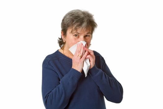 Senior woman blowing her nose - isolated on white background