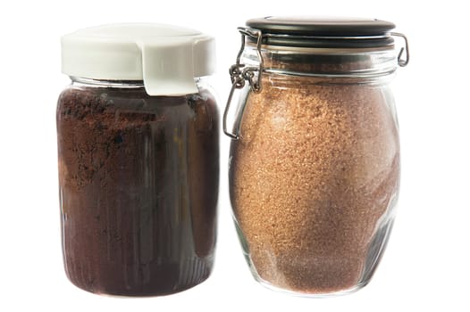jar of ground coffee and sugar cane on white background