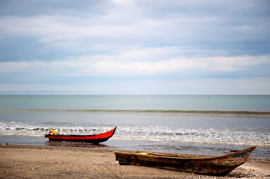 Old fishing boat on a beach on the coast of Ecuador