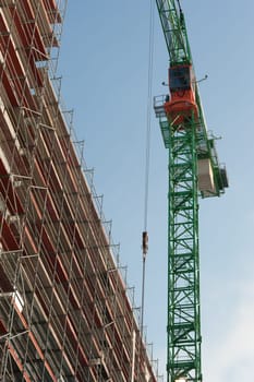 Construction crane with scaffolding