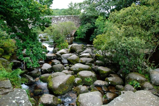 bridge over a river with rocks in the park of Dartmoor in Cornwall