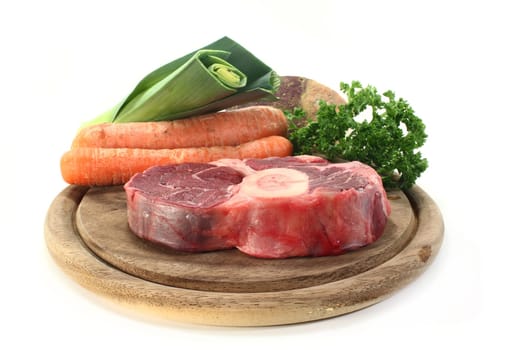 Cooked meat and soup vegetables on a wooden board