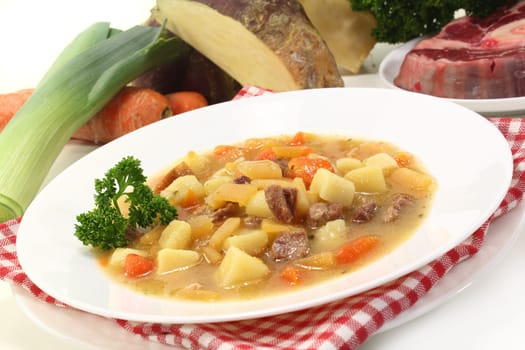 a plate of rutabaga stew with parsley and boiled meat