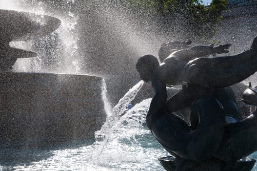 Detail of statue by water fountain in Trafalgar Square, central London, UK