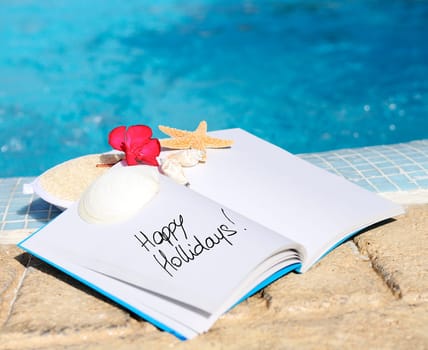 open book with strfish outdoor with swiming pool background