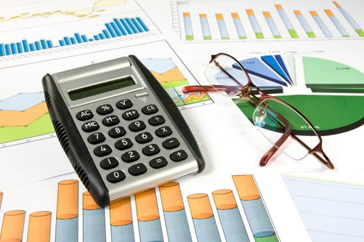business concept. colorful  charts, calculator and glasses