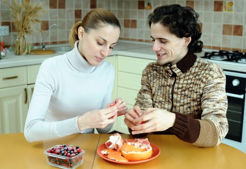 An image of young couple eating at kitchen