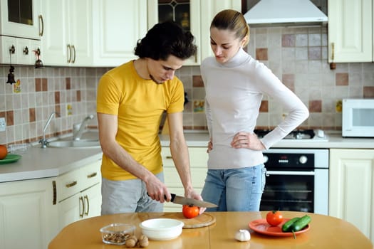 An image of couple in the kichen preparing vegetarian food