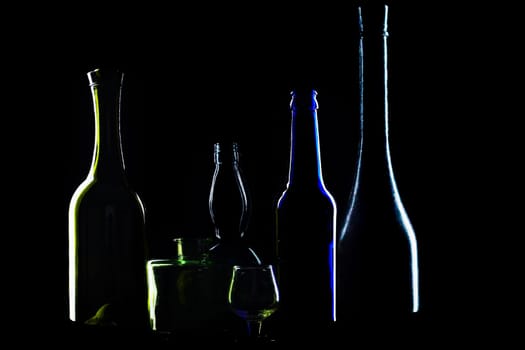 An image of silhouettes of bottles on black background