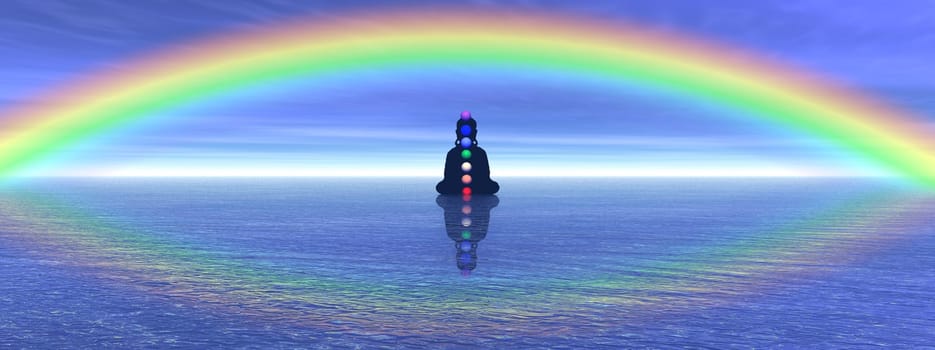 Shadow in meditation with chakras on the ocean and under a big beautiful rainbow