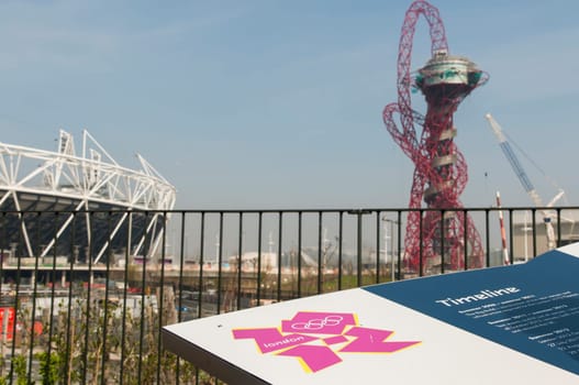 LONDON, UK – MARCH 24: Details of information board with London Olympics logo and Stadium and sculpture in the background on March 24, 2012 in London. The Olympic Park is due to be ready in summer.