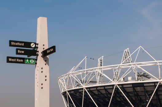 LONDON, UK – MARCH 24: Details of sign post with Olympic stadium in the background on March 24, 2012 in London. All locations around the Olympic Park are undergoing redevelopment works.
