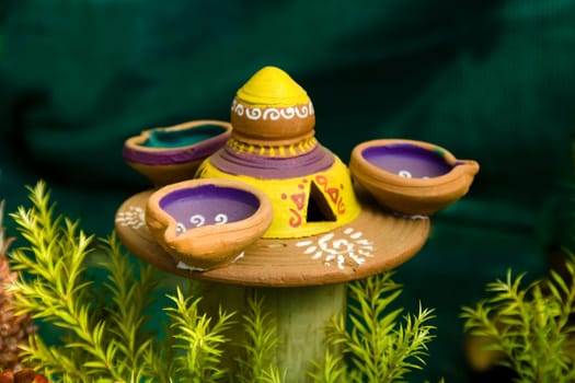 Three lamps and lamp stand made of red earth tastefully decorated with paint