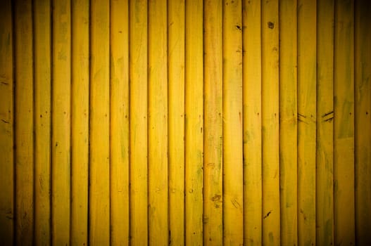Yellow wood wall background with vignette