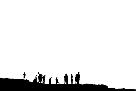 Silhouette of crowd of people on the peak or edge of a cliff in ireland with clipping path