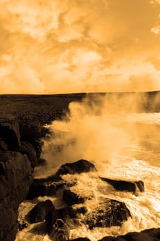 cliffs and coastline of the burren in county clare ireland with giant waves crashing on the rocks in storm