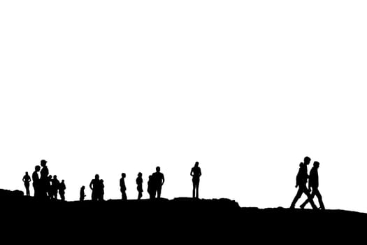 Silhouette of crowd of people on the peak or edge of a cliff in ireland with clipping path
