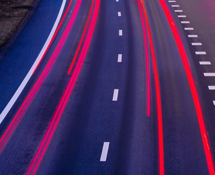 blurred lights of cars on a highway at evening